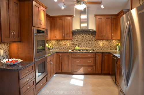 Baltic Brown Countertop with Cinnamon Glazed Cherry Cabinets,Beige Melange Glass Mosaic Tiles, Porcelain Flooring and Stainless Steel Appliance